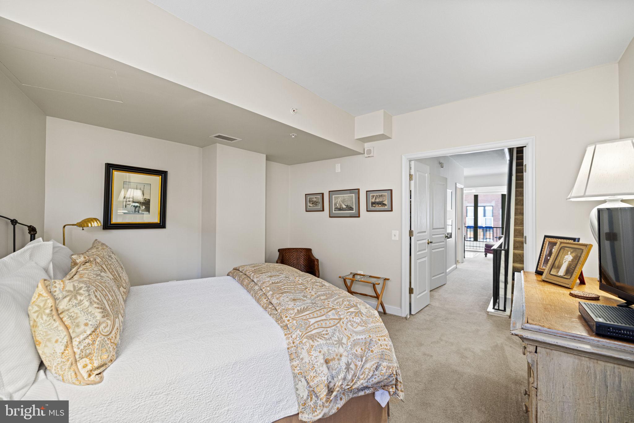 616 E Street Northwest, Unit 1152 Washington, DC 20004 - Photo 18 of 92 a bedroom with a bed and a painting on the wall