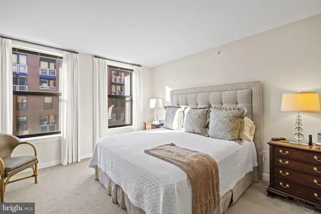 a bathroom with a double vanity sink a mirror and a bathtub