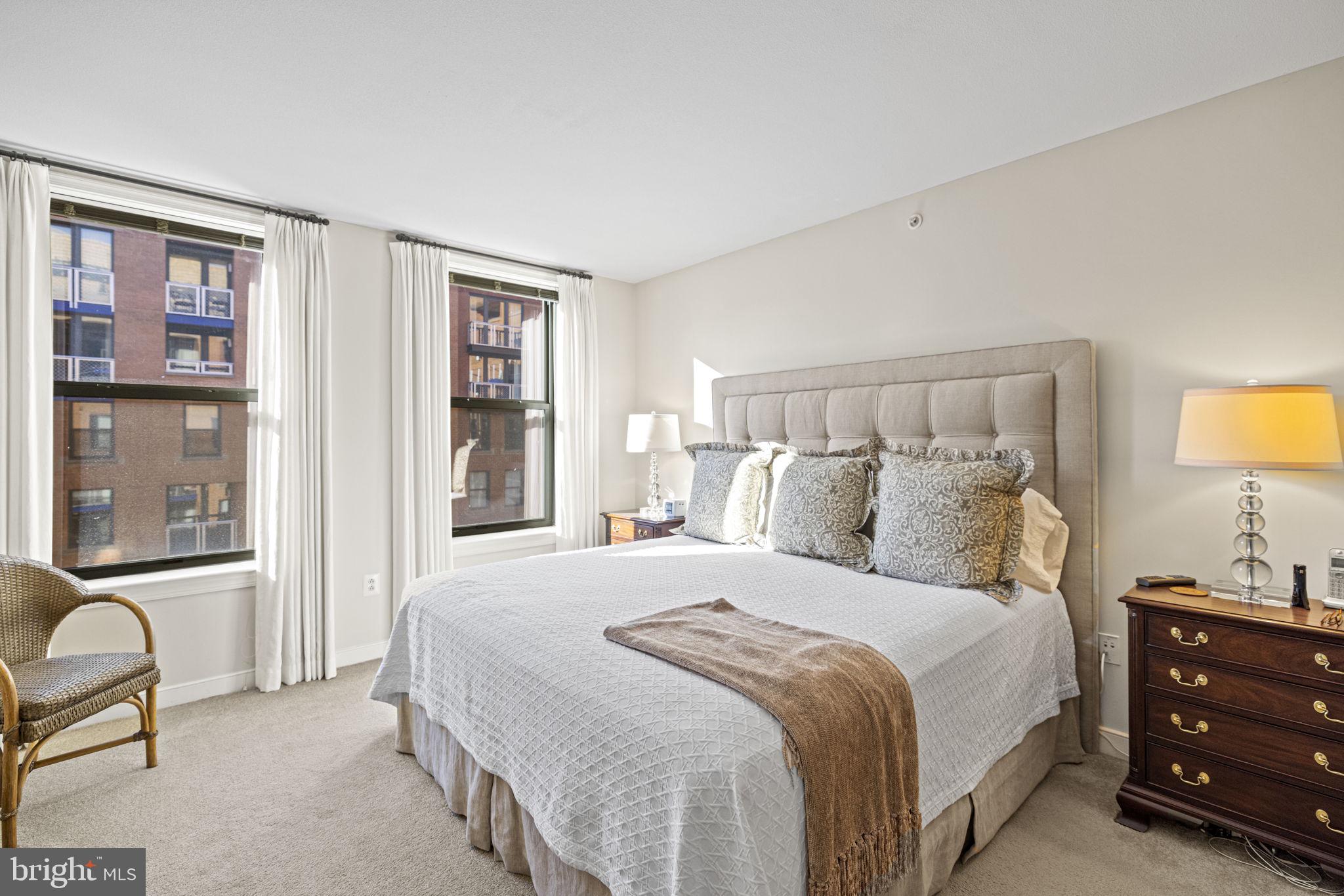 616 E Street Northwest, Unit 1152 Washington, DC 20004 - Photo 20 of 92 a bedroom with a bed and wooden floor
