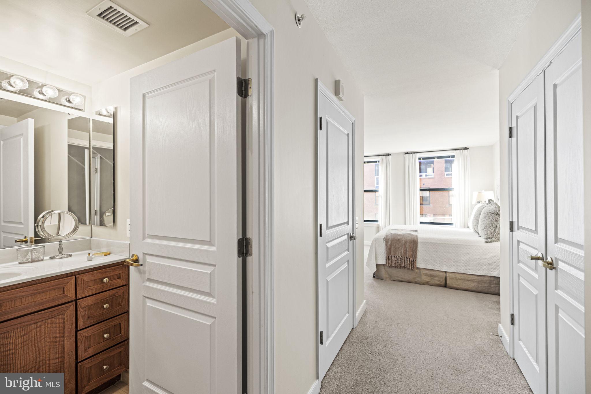 616 E Street Northwest, Unit 1152 Washington, DC 20004 - Photo 24 of 92 a bathroom with a double vanity sink a mirror and a bathtub