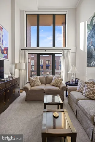 a view of a livingroom with wooden floor and a ceiling fan