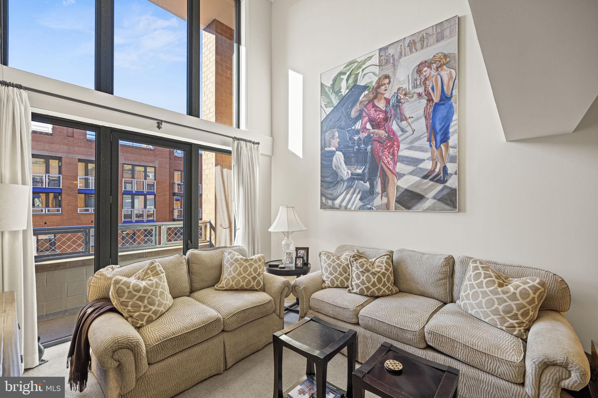616 E Street Northwest, Unit 1152 Washington, DC 20004 - Photo 8 of 92 a living room with furniture and a large window with rug