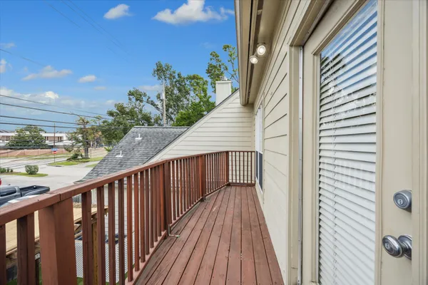 a view of a balcony with wooden floor