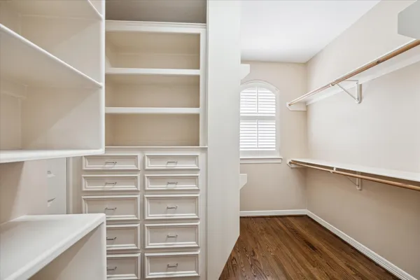 a view of walk in closet with empty racks