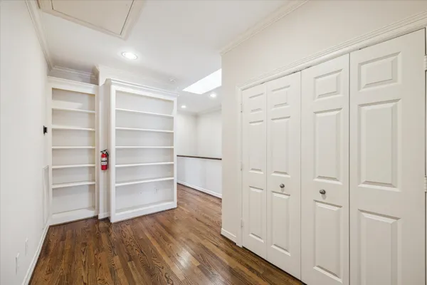 a view of walk in closet with empty racks