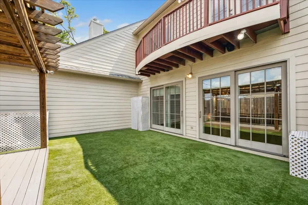 a view of a backyard with large trees and plants