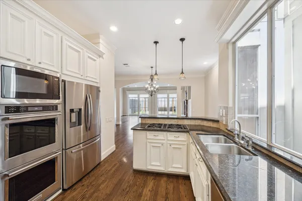 a kitchen with a stove a sink and a refrigerator