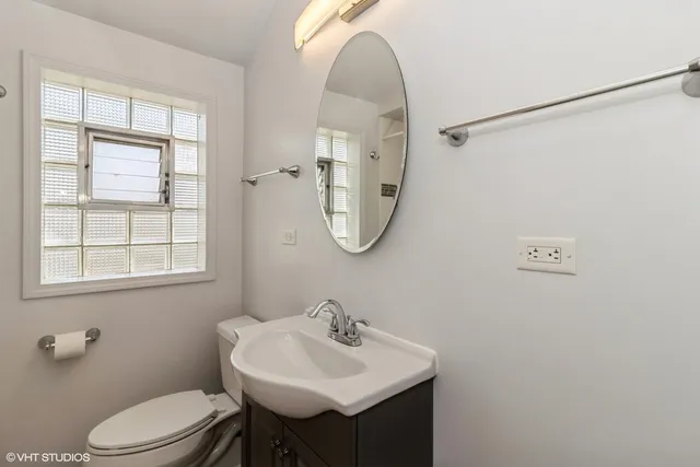a bathroom with a sink a toilet and a mirror