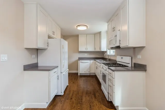 a kitchen with stainless steel appliances a sink stove and cabinets