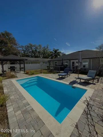 a view of swimming pool with chairs