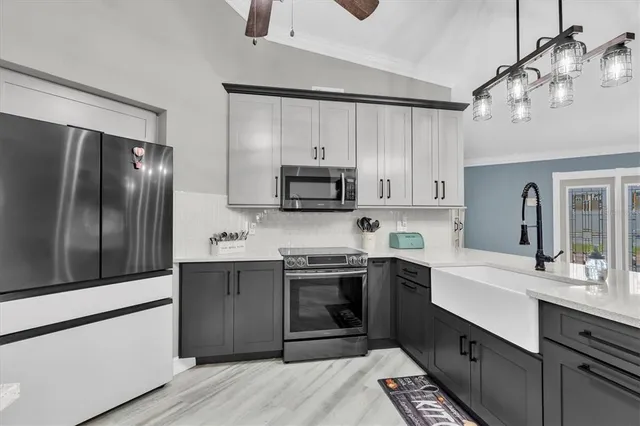 a kitchen with stainless steel appliances granite countertop a sink stove and refrigerator