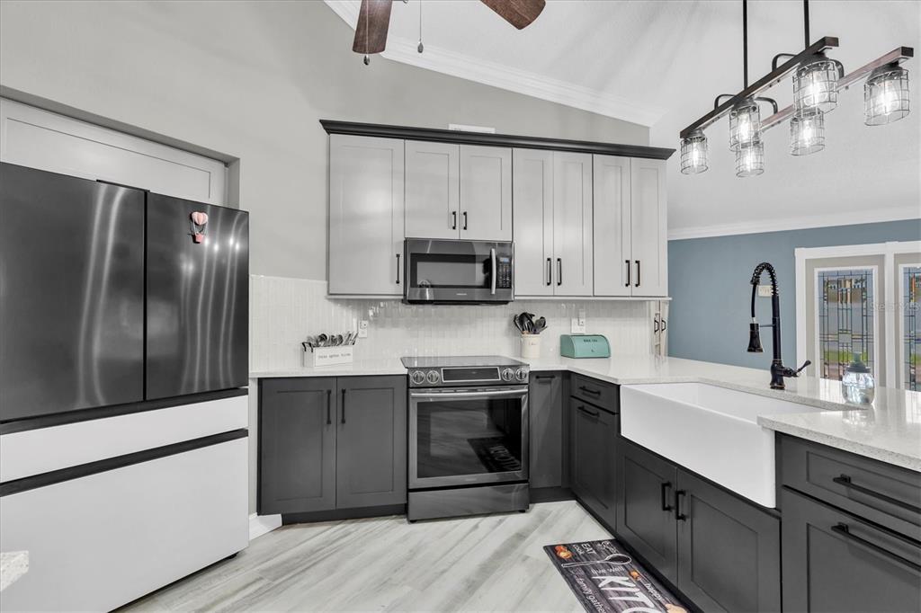 1170 Falcon Ridge Lane Palm Harbor, FL 34683 - Photo 11 of 35 a kitchen with stainless steel appliances granite countertop a sink stove and refrigerator