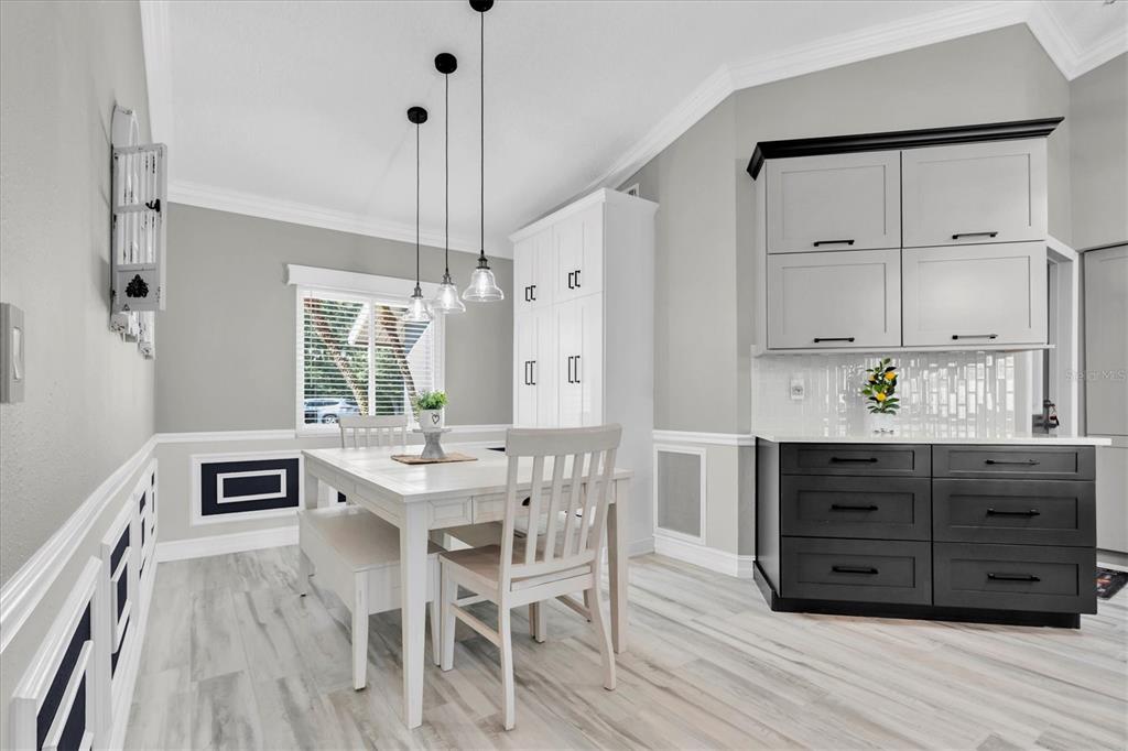 1170 Falcon Ridge Lane Palm Harbor, FL 34683 - Photo 14 of 35 a kitchen with stainless steel appliances a table chairs and wooden floor