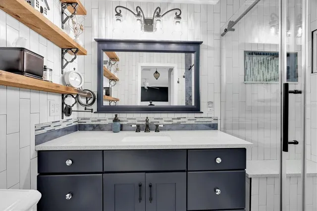 a bathroom with a sink vanity and a mirror