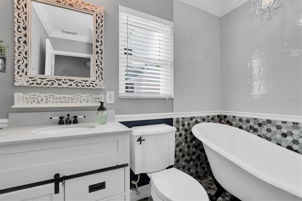1170 Falcon Ridge Lane Palm Harbor, FL 34683 - Photo 22 of 35 a bathroom with a sink a toilet and a mirror