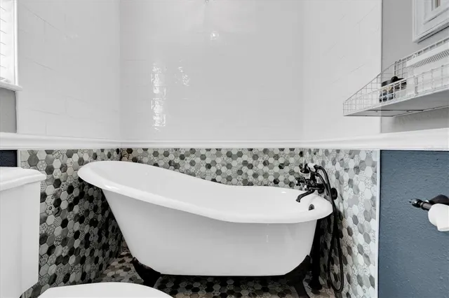 a bathroom with a bathtub and a sink