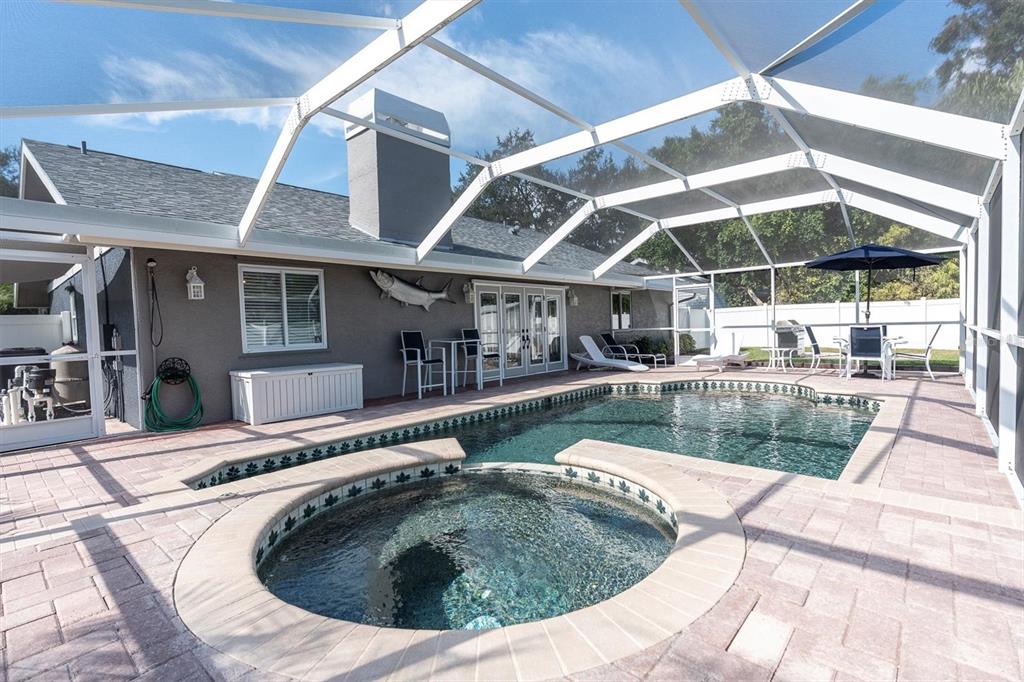 1170 Falcon Ridge Lane Palm Harbor, FL 34683 - Photo 28 of 35 a view of roof deck with table and chairs under an umbrella