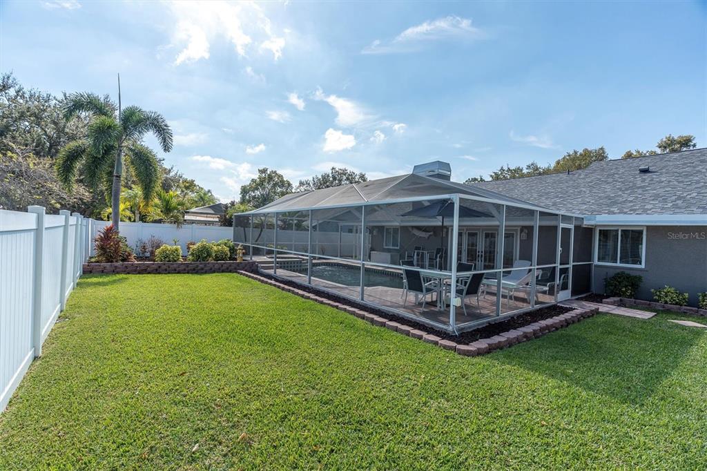 1170 Falcon Ridge Lane Palm Harbor, FL 34683 - Photo 31 of 35 a view of a house with backyard and sitting area
