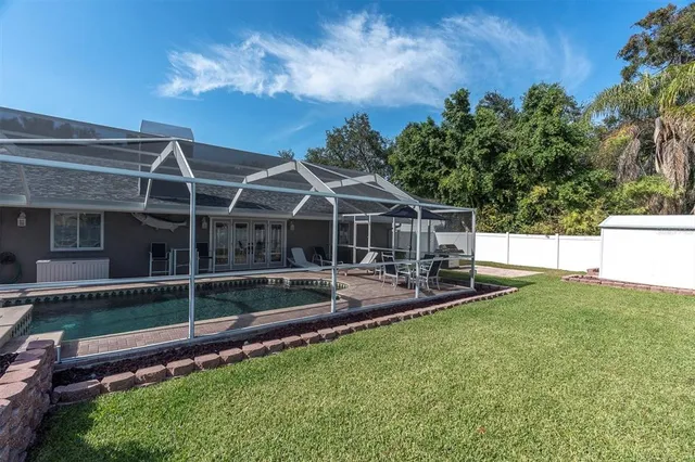 a view of a house with swimming pool and sitting area