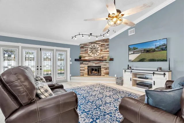 a living room with furniture a fireplace and a flat screen tv