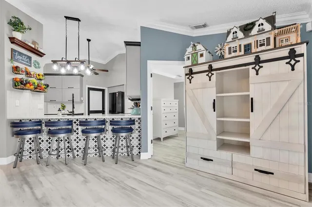 an open kitchen with granite countertop a stove and cabinets