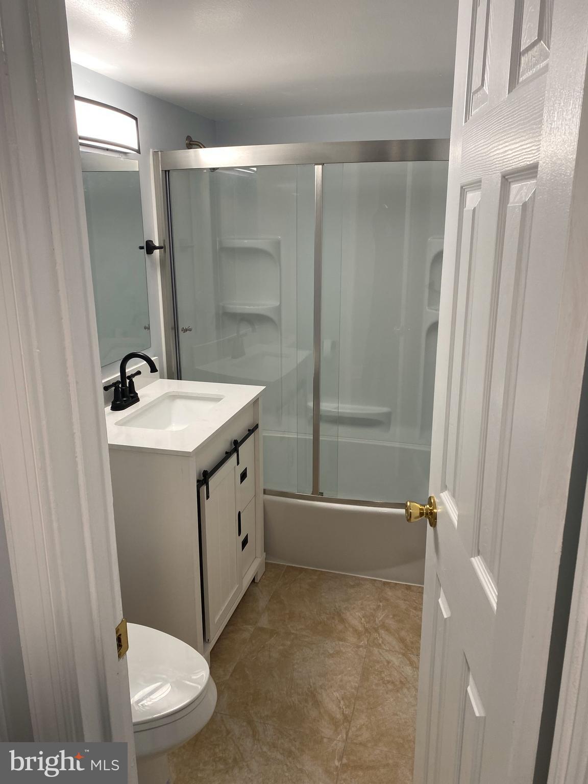 7515 Spring Lake Drive, Unit D2 Bethesda, MD 20817 - Photo 2 of 8 a bathroom with a sink a toilet and shower