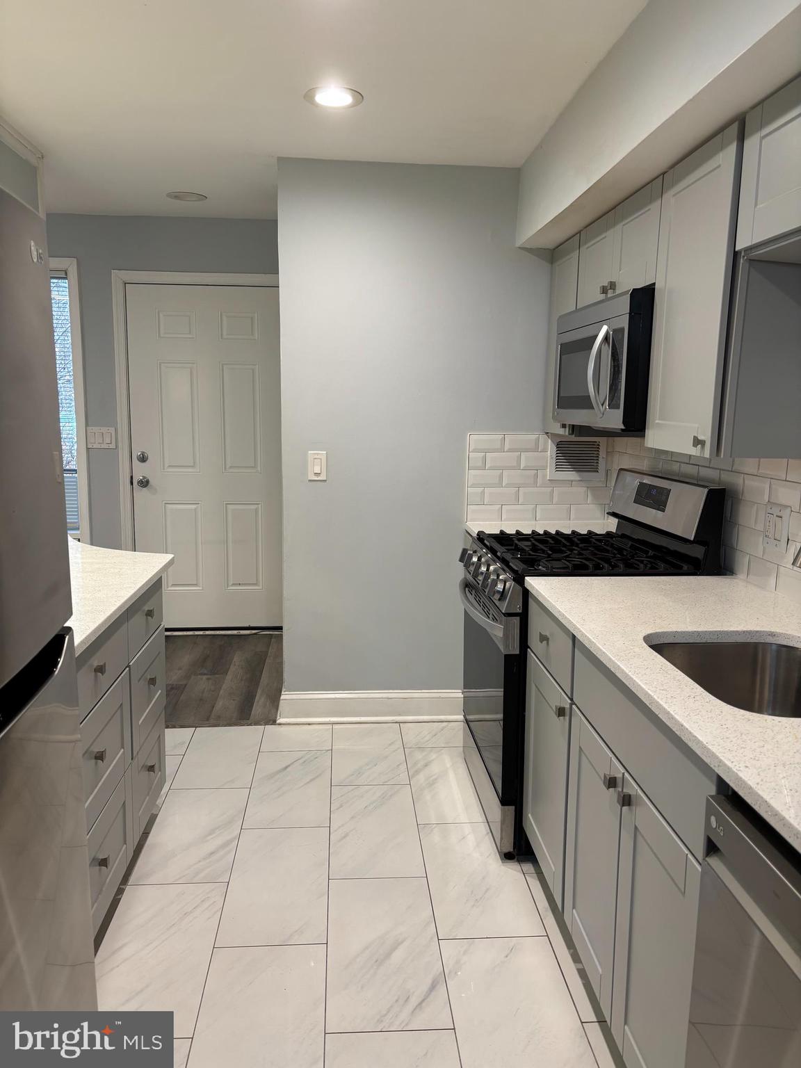 7515 Spring Lake Drive, Unit D2 Bethesda, MD 20817 - Photo 6 of 8 a kitchen with a sink stove and cabinets