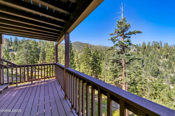 a view of balcony with wooden floor and fence