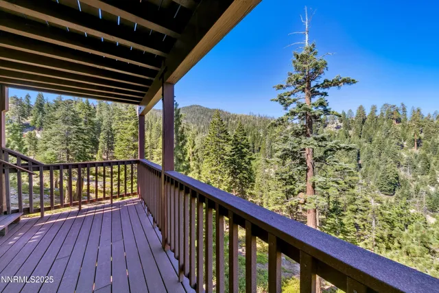 a view of balcony with wooden floor and fence