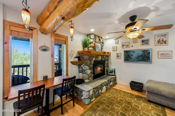 a living room with furniture a fireplace and a chandelier