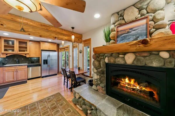 a living room with furniture a fireplace and wooden floor