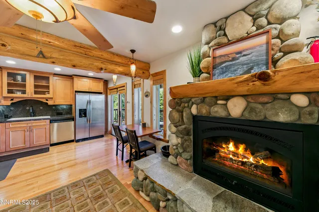 a living room with furniture a fireplace and wooden floor
