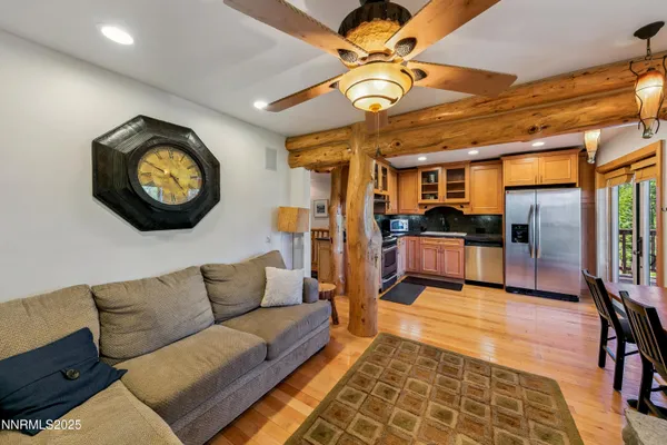 a living room with furniture and kitchen view
