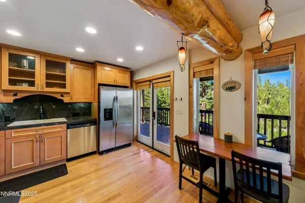 a kitchen with stainless steel appliances granite countertop lots of counter top space and wooden floor