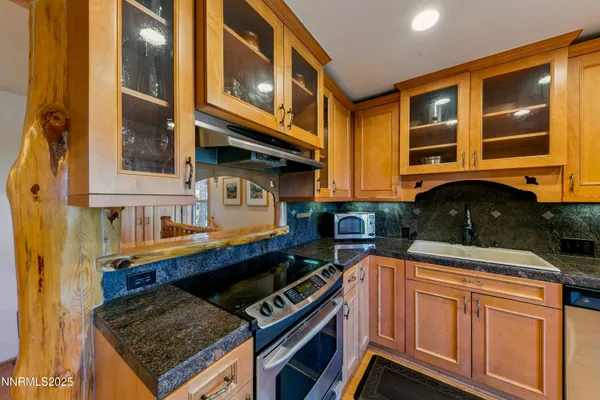 a kitchen with stainless steel appliances granite countertop a stove and a cabinets