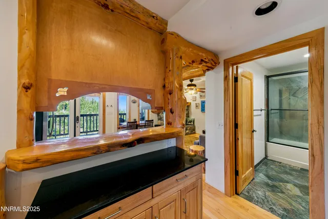 a large white kitchen with a large window