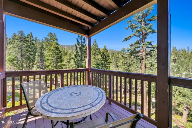 a view of a balcony with furniture and a wooden floor