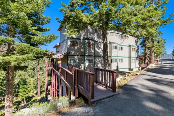 a view of a house with large tree