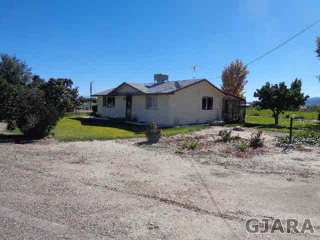 2049 I Road Fruita, CO 81521 - Photo 3 of 30 a view of a house with a yard and large tree