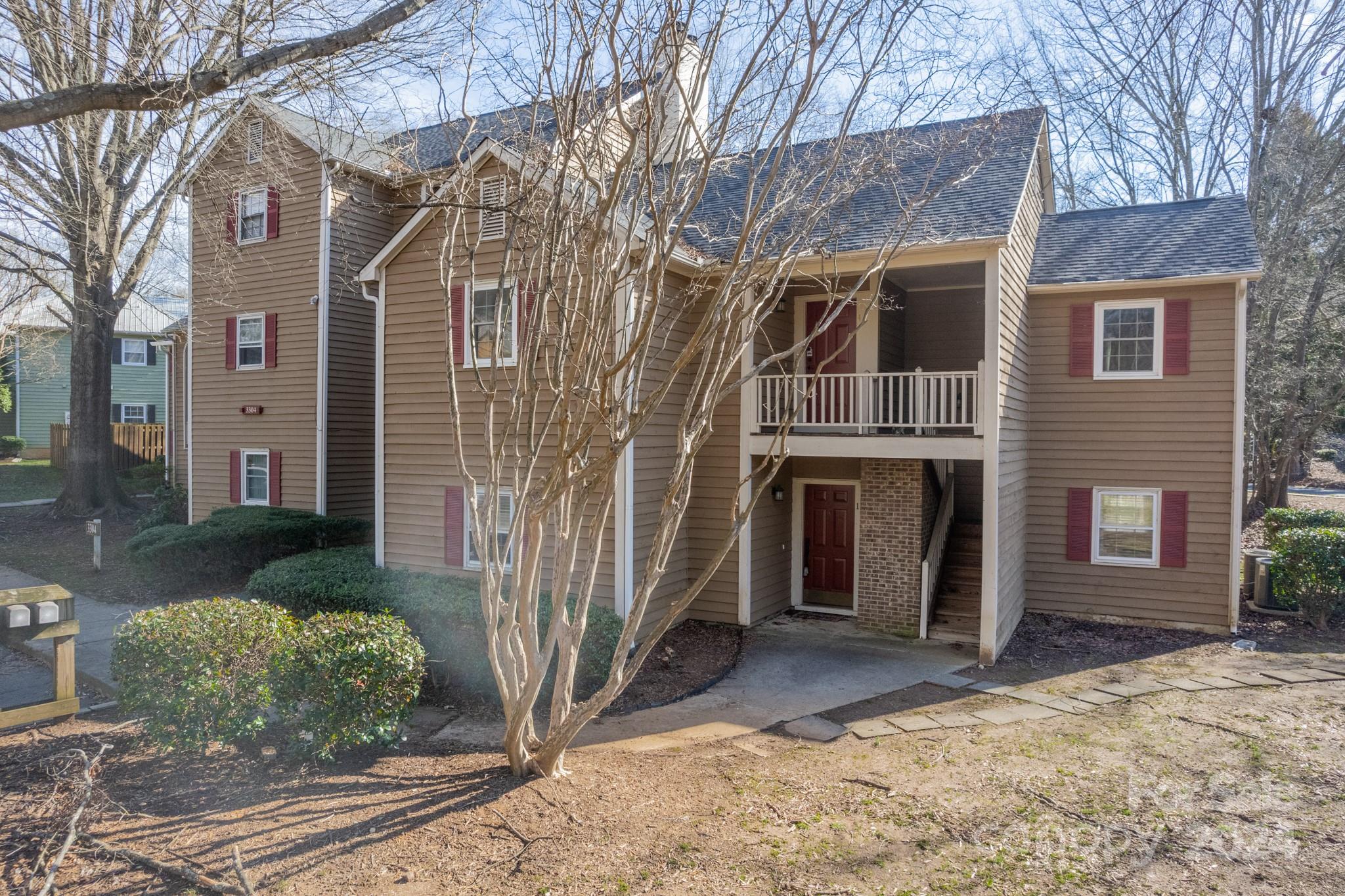3304 Selwyn Farms Lane, Unit 1 Charlotte, NC 28209 - Photo 1 of 27 a view of a house with a yard and garage