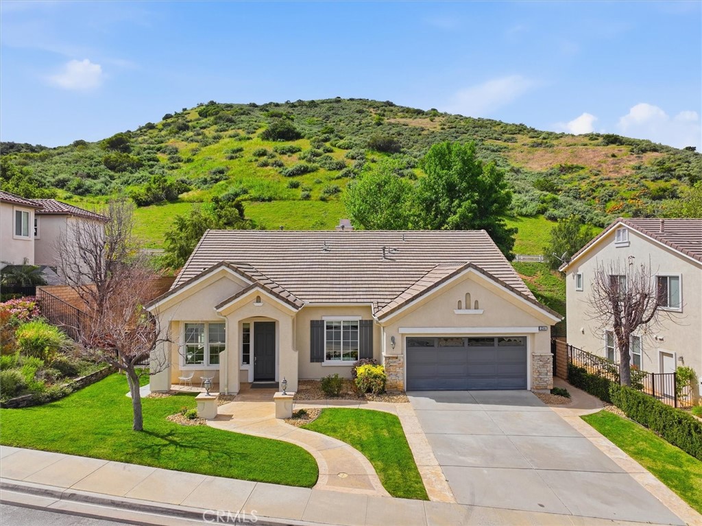5244 Huckleberry Oak Street Simi Valley, CA 93063 - Photo 1 of 1 a front view of a house with a yard and garage