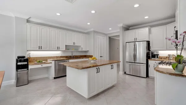 a kitchen with granite countertop a stainless steel appliances and cabinets