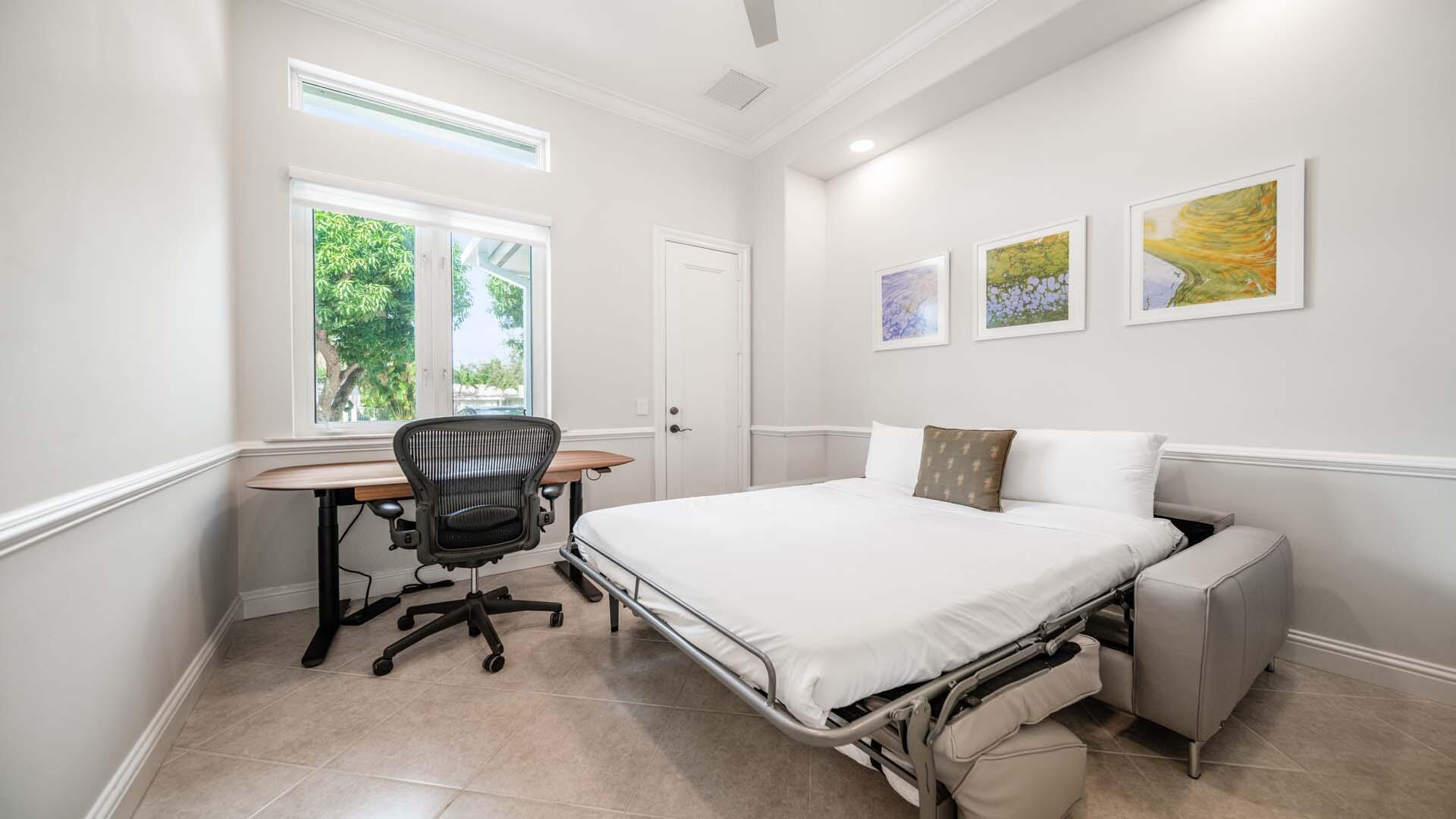 514 Northwest 13th Street Delray Beach, FL 33444 - Photo 28 of 35 a bedroom with a bed a table and a window