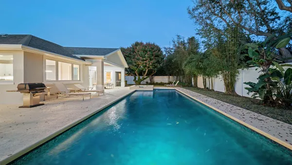 a view of a swimming pool with an outdoor seating