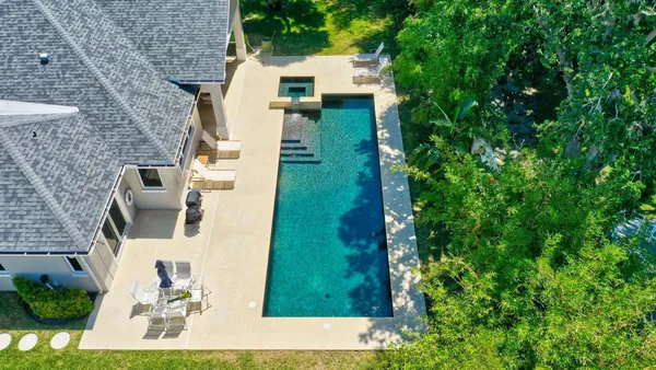 a view of a backyard with a swimming pool