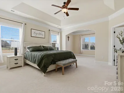 a bedroom with a bed and a chandelier