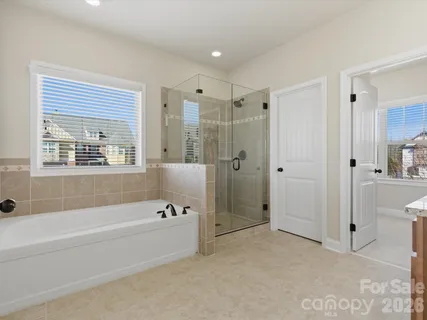 a spacious bathroom with a bathtub and a shower
