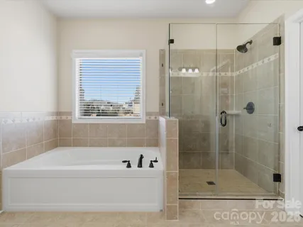 a bathroom with a bathtub and a shower