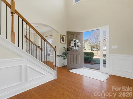 a view of a livingroom with wooden floor and stairs