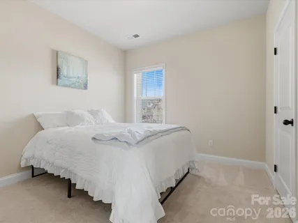 a bedroom with a bed and a lamp